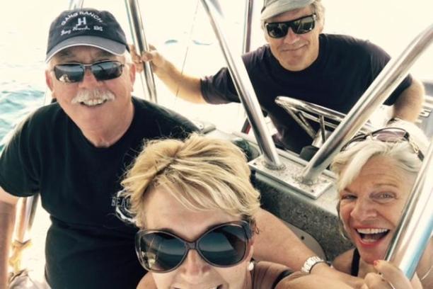 four people having a good time on a boat