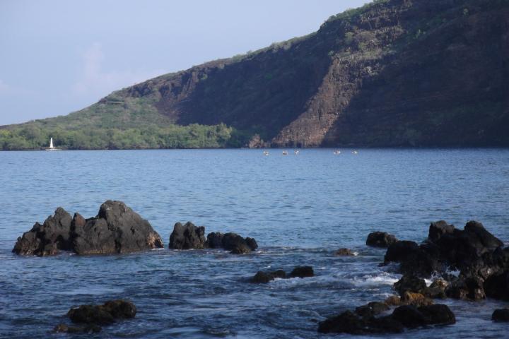 the bay with cliffs and monument in background