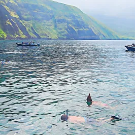 a body of water with a mountain in the background
