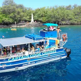 a blue and white boat floating on a body of water