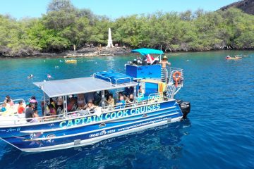 a blue and white boat floating on a body of water